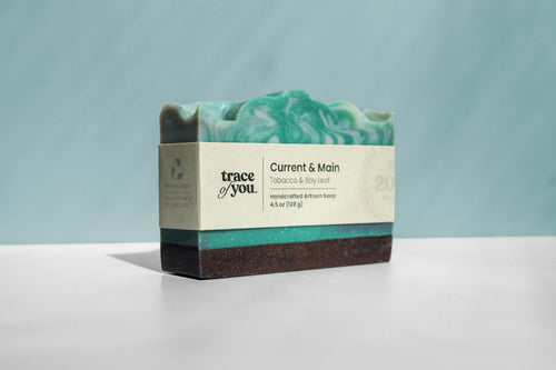 Bar of soap with a visible brand label on a light blue background