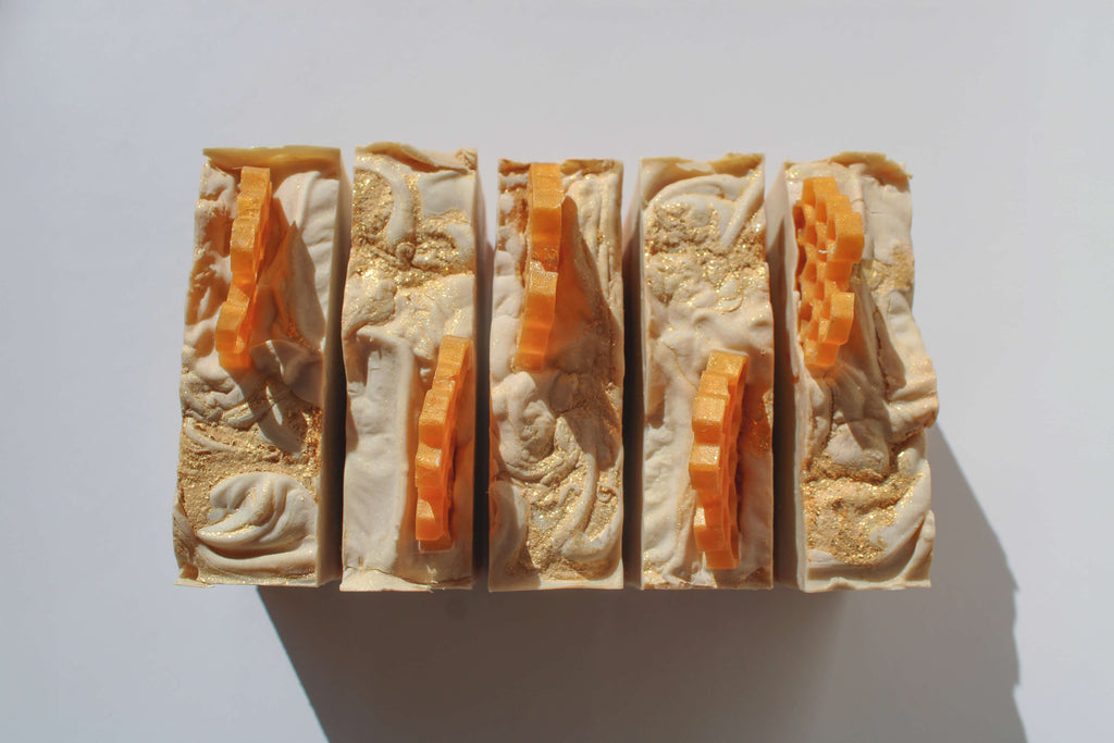 Five stacked soap bars with a textured surface on a white background