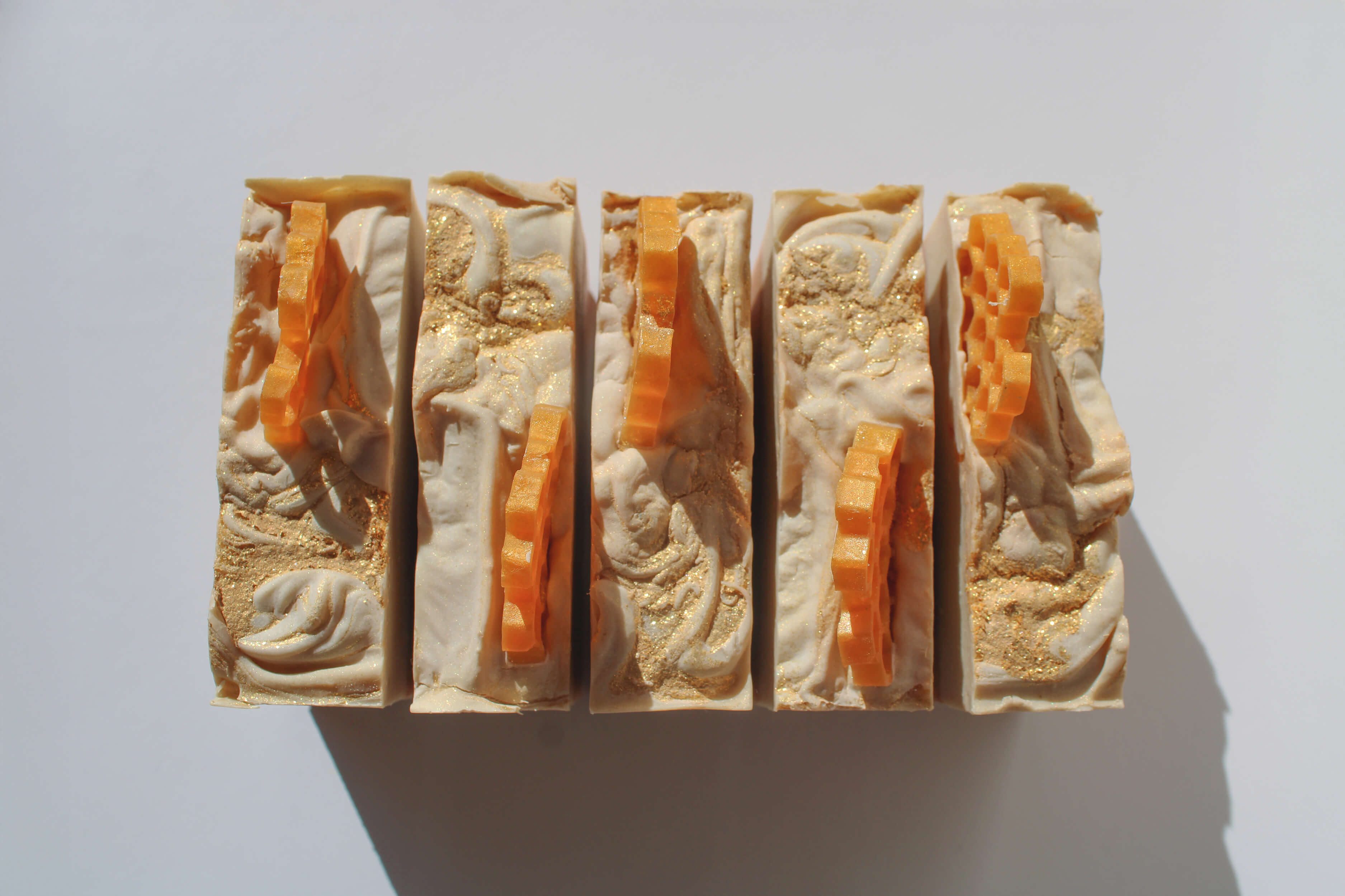 Five stacked soap bars with a textured surface on a white background