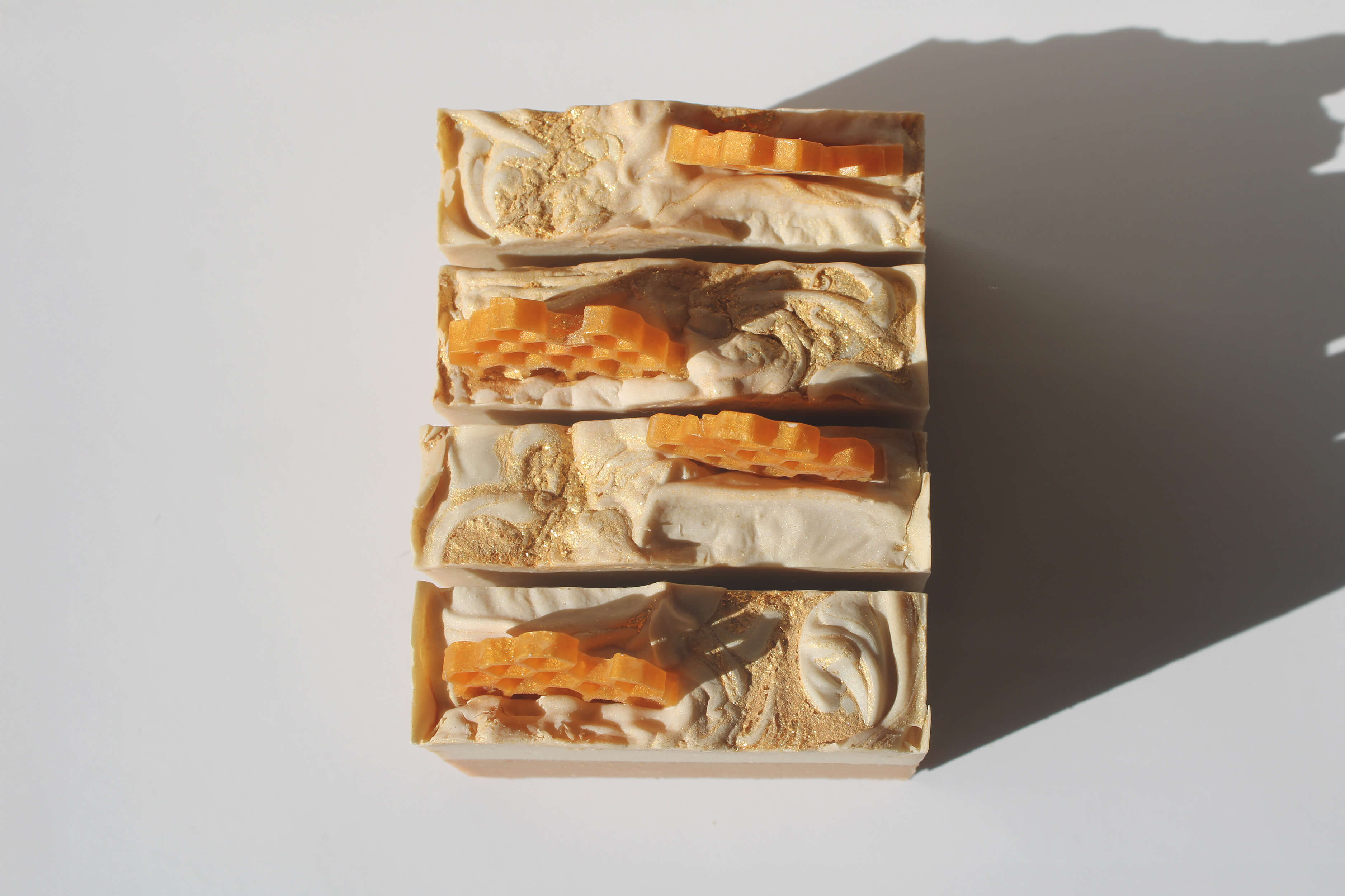 Bar of soap with honeycomb patterns on a white background