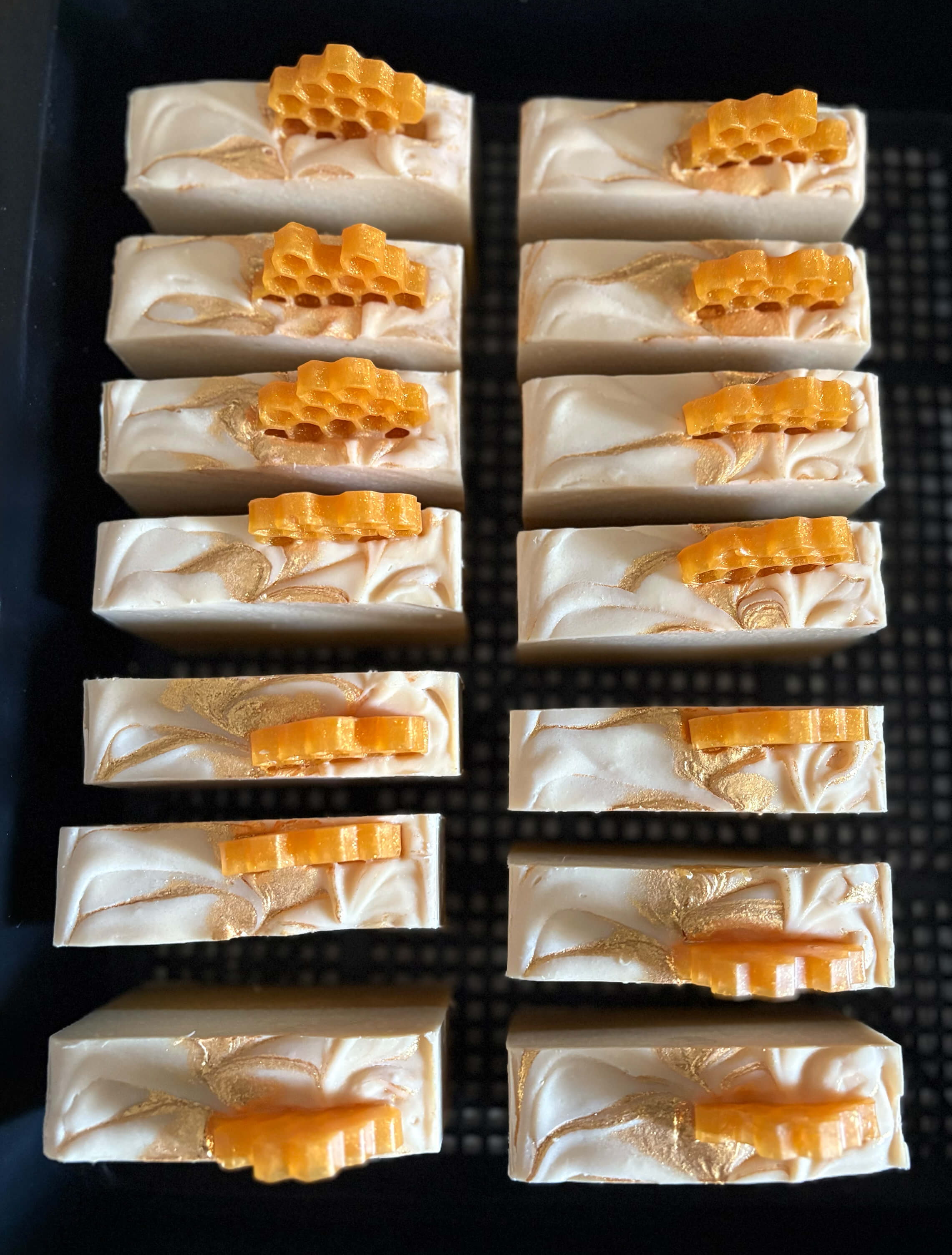 Bars of soap with honeycomb design on a black tray