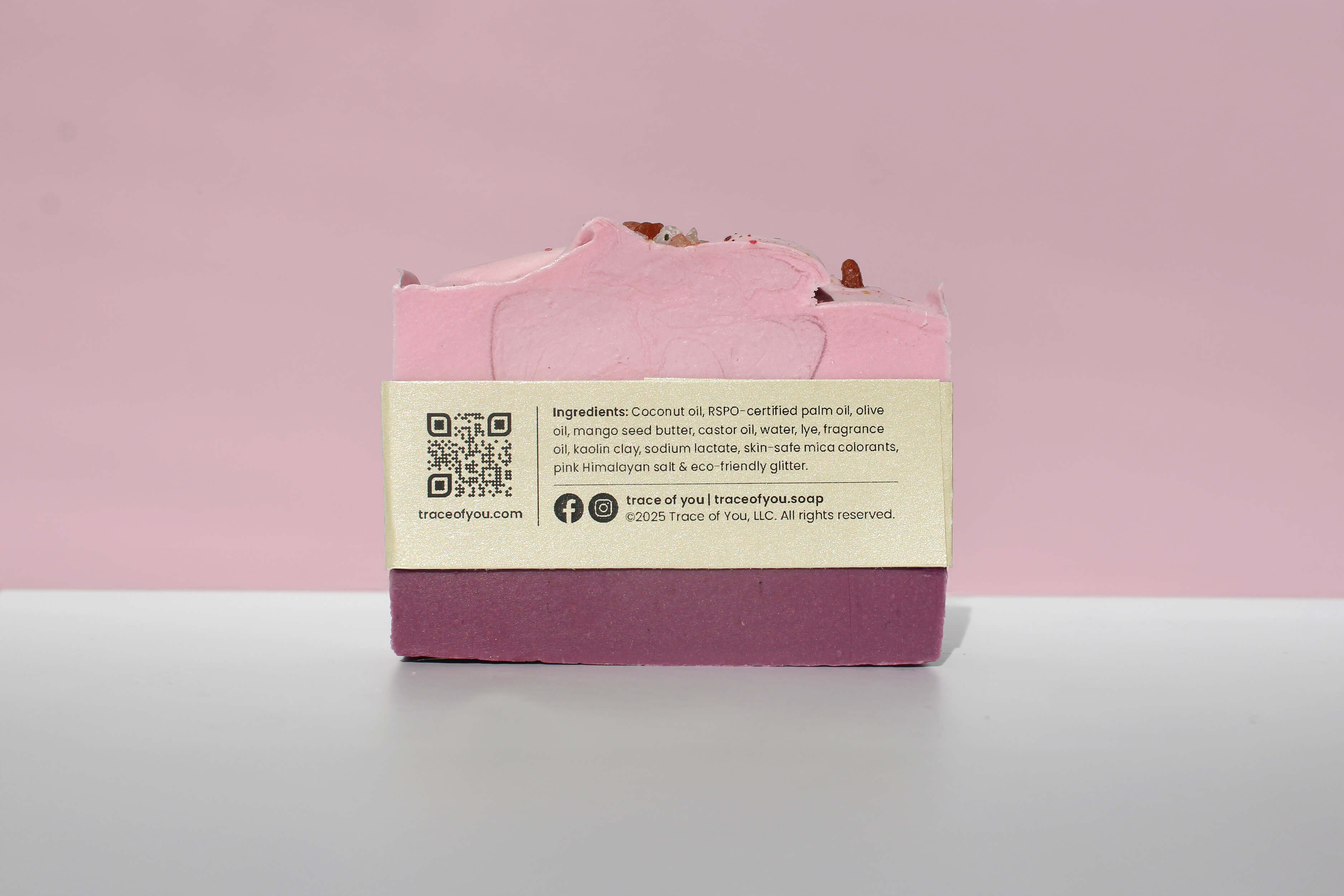 Pink soap bar with a label on a pink background