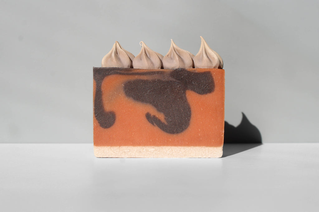 Bar of soap with an orange, brown and beige design on a gray background