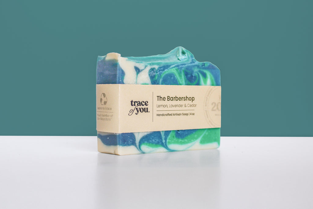 Bar of soap with a visible brand label on a teal background