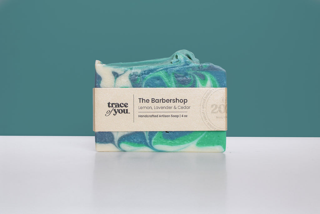 Bar of soap with a label on a white surface and teal background