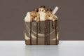 Espresso dessert soap with whipped cream and chocolate drizzle on a white surface with a brown background